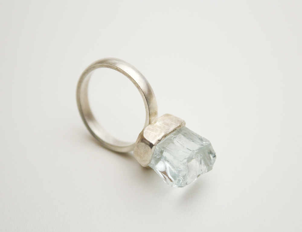 Sterling silver ring with a freeform chunk of glass set in a silver bezel.
