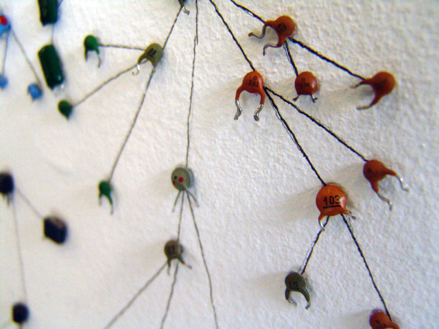 Close up of some of the capacitor 'creatures' - round brown and green in shape